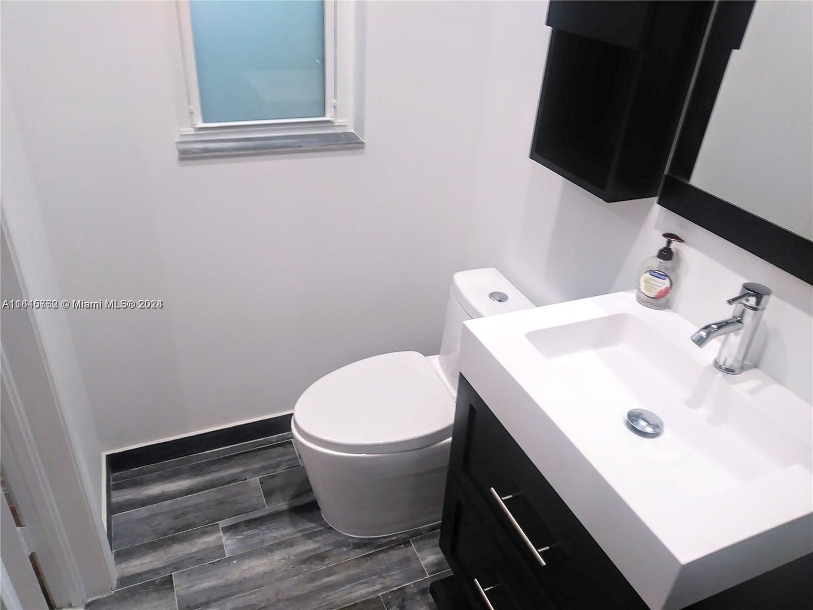 610 Southwest 25th Road Miami, FL 33129 - Photo 16 of 30 a bathroom with a sink and a toilet