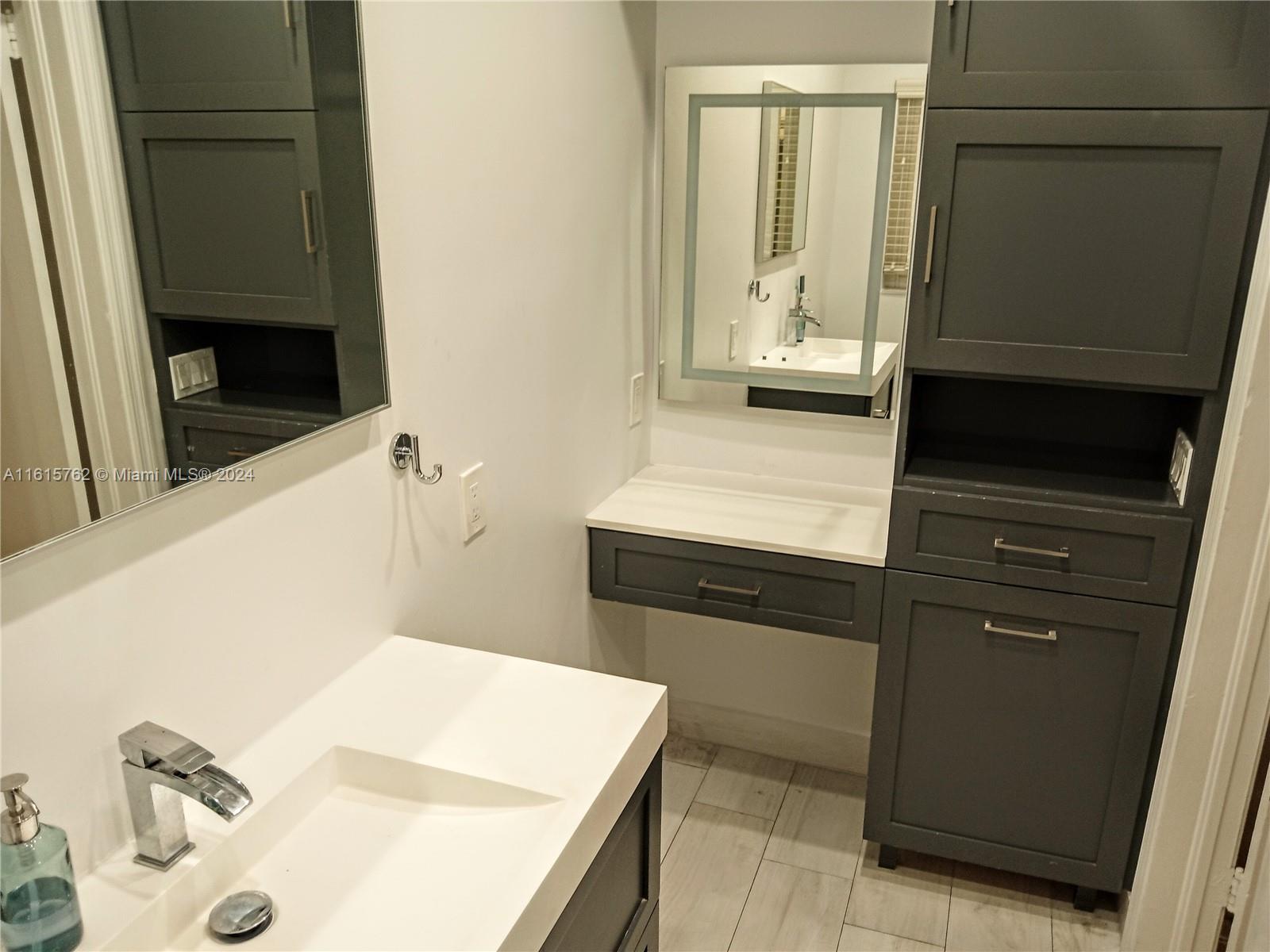 610 Southwest 25th Road Miami, FL 33129 - Photo 18 of 30 a bathroom with a sink and a mirror