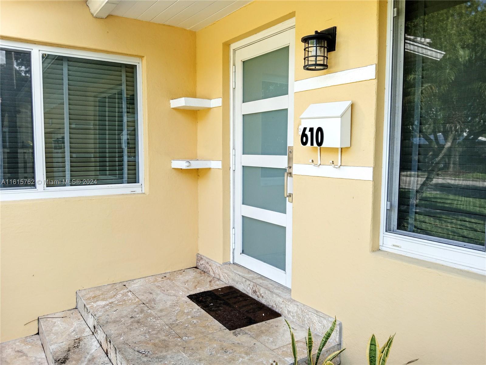 610 Southwest 25th Road Miami, FL 33129 - Photo 2 of 30 a front view of a house with a yard