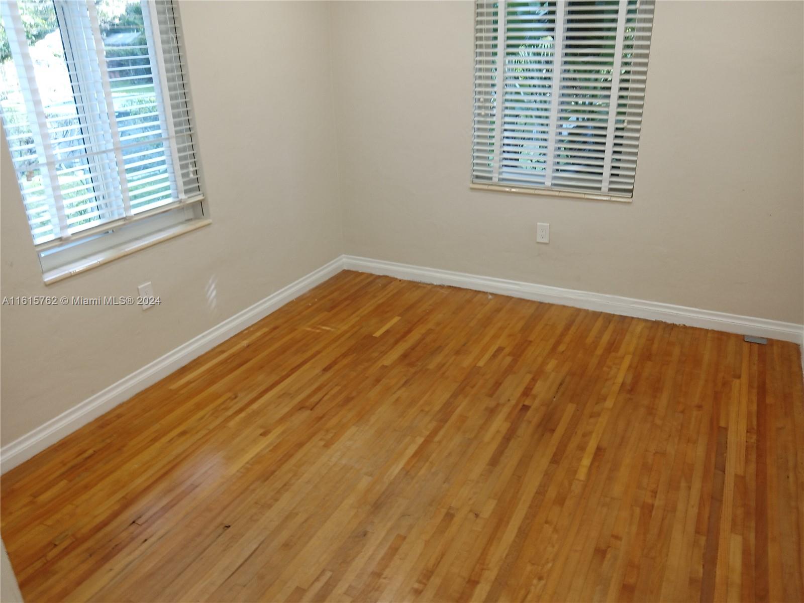 610 Southwest 25th Road Miami, FL 33129 - Photo 27 of 30 a view of wooden floor and windows in a room