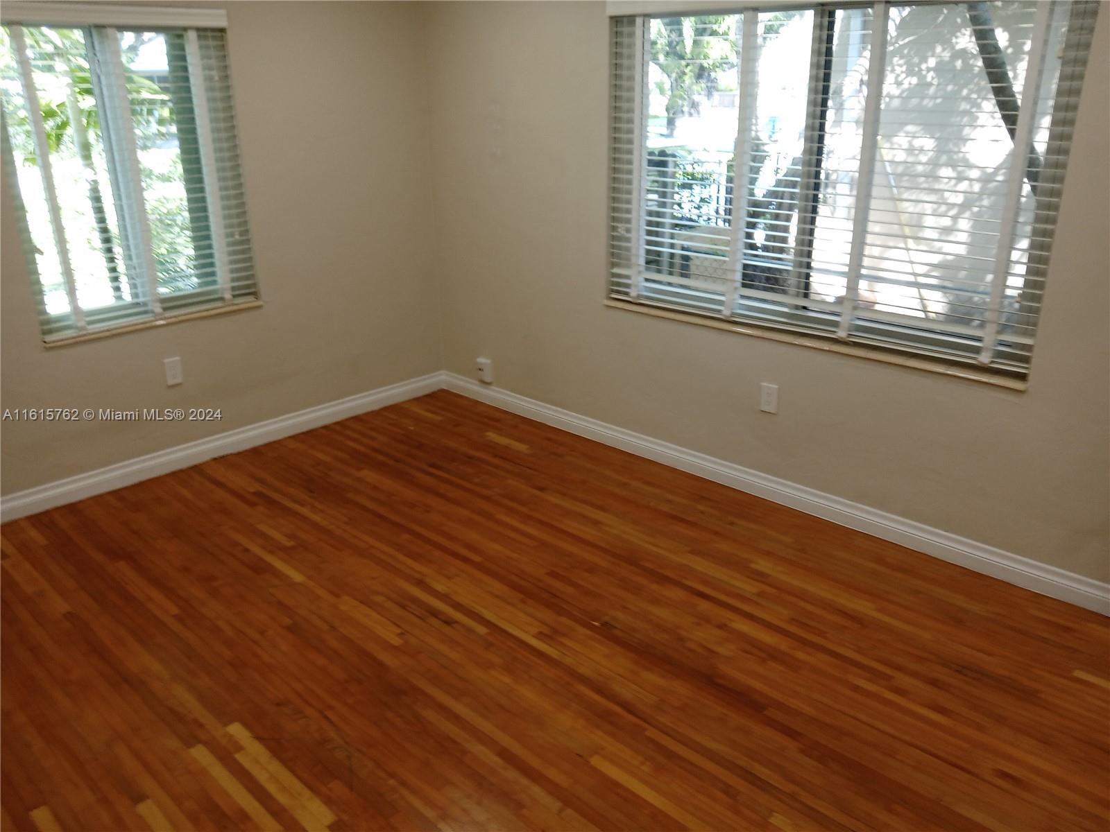 610 Southwest 25th Road Miami, FL 33129 - Photo 29 of 30 an empty room with wooden floor and windows