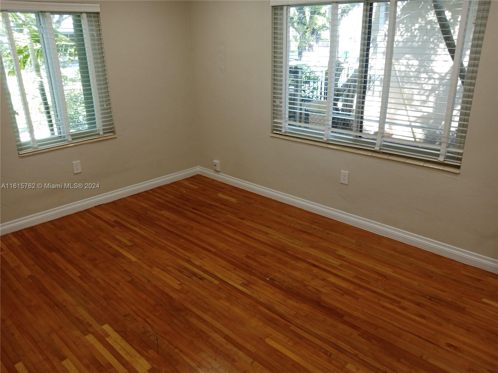 610 Southwest 25th Road Miami, FL 33129 - Photo 30 of 30 an empty room with wooden floor and windows