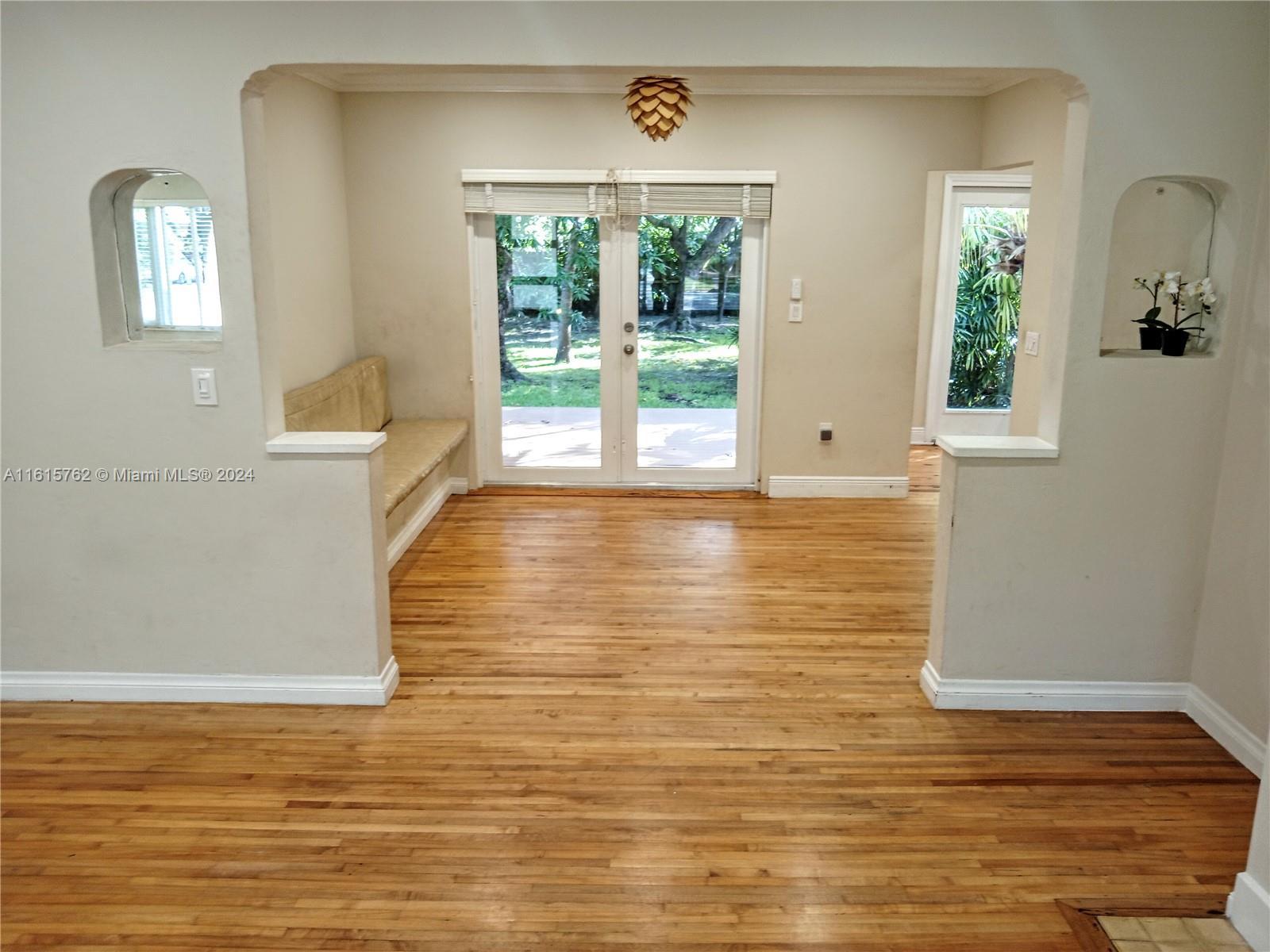 610 Southwest 25th Road Miami, FL 33129 - Photo 3 of 30 a view of a room with wooden floor and windows