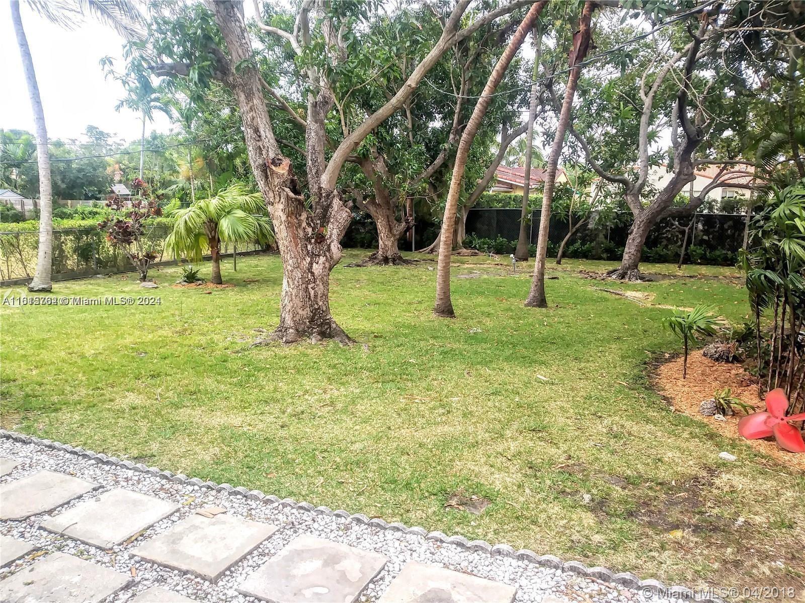 610 Southwest 25th Road Miami, FL 33129 - Photo 5 of 30 a view of a backyard with a tree