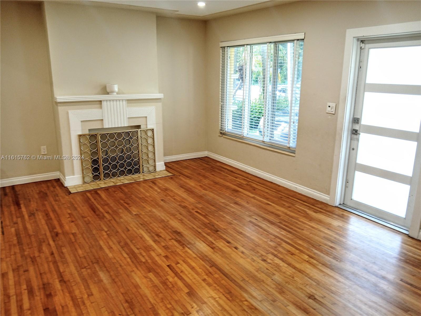 610 Southwest 25th Road Miami, FL 33129 - Photo 8 of 30 an empty room with windows and fireplace