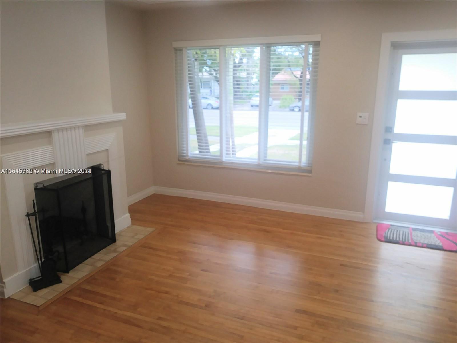610 Southwest 25th Road Miami, FL 33129 - Photo 9 of 30 wooden floor fireplace and windows in an empty room