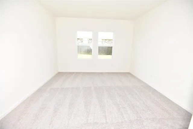 a view of a small space with wooden floor and a window