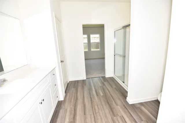 a view of hallway with wooden floor