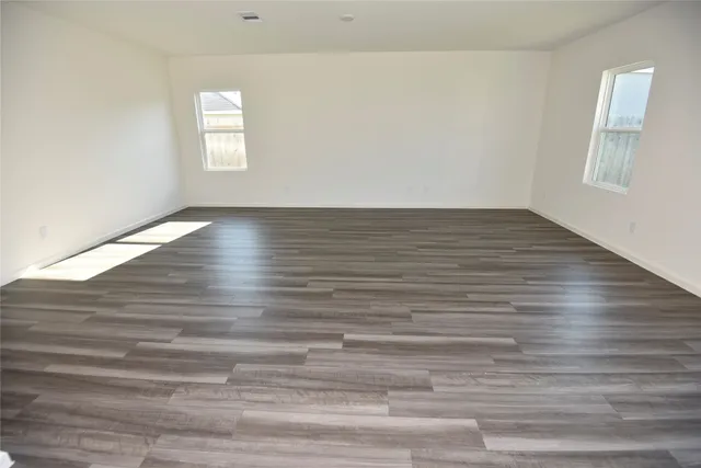 a view of wooden floor and windows in a room