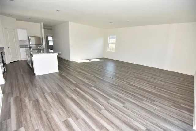 a view of kitchen and hall with wooden floor