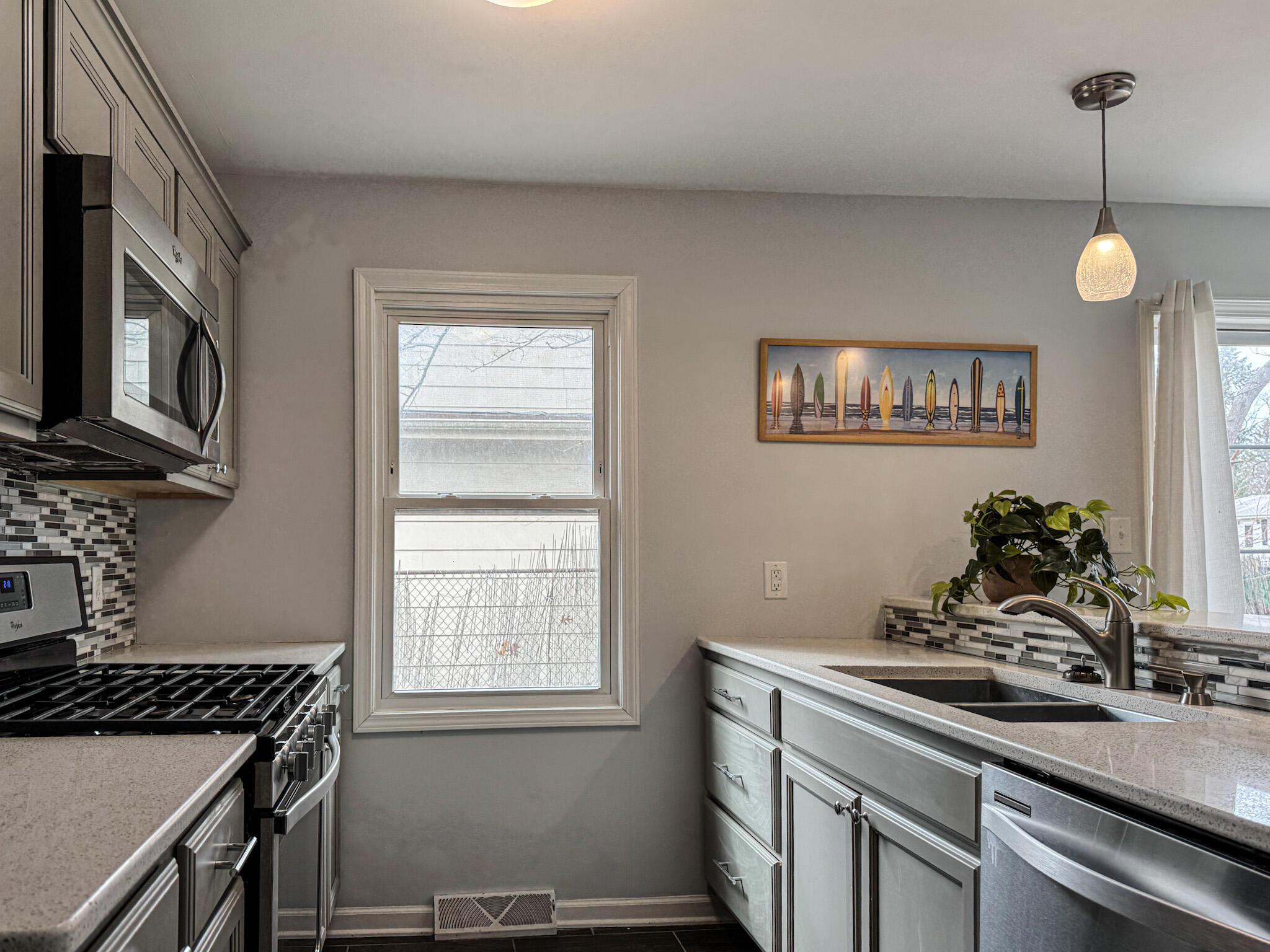 217 Loran Road Michigan City, IN 46360 - Photo 11 of 26 a kitchen with stainless steel appliances granite countertop a sink a stove and a wooden floors