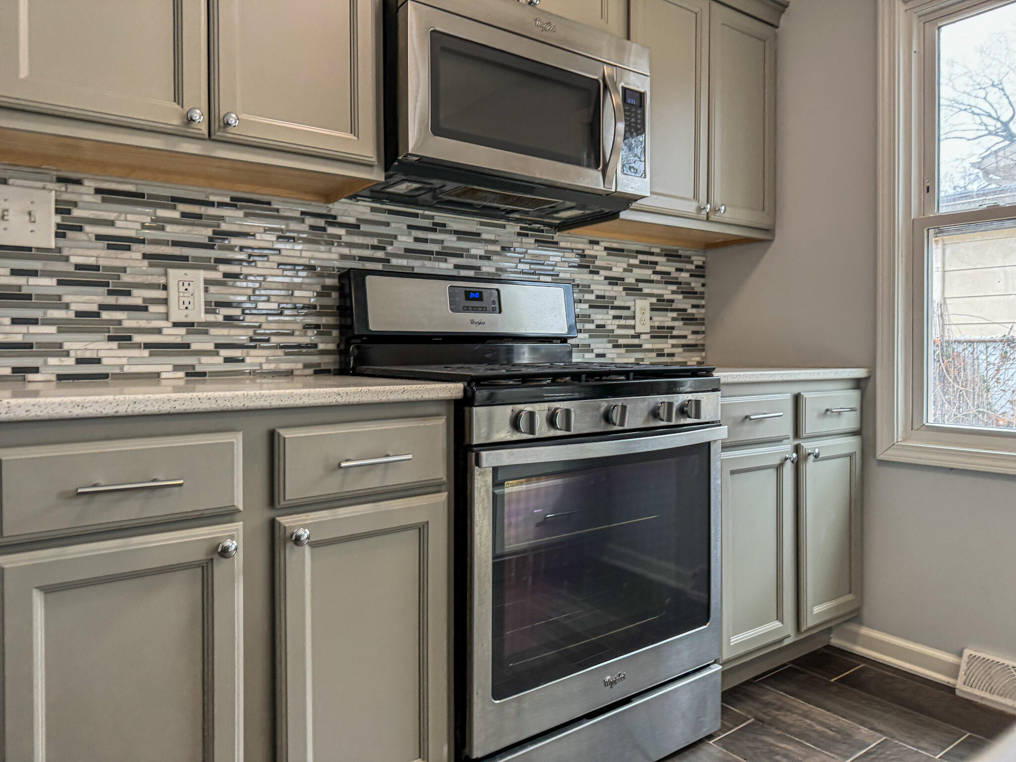 217 Loran Road Michigan City, IN 46360 - Photo 12 of 26 a kitchen with granite countertop cabinets stainless steel appliances and window