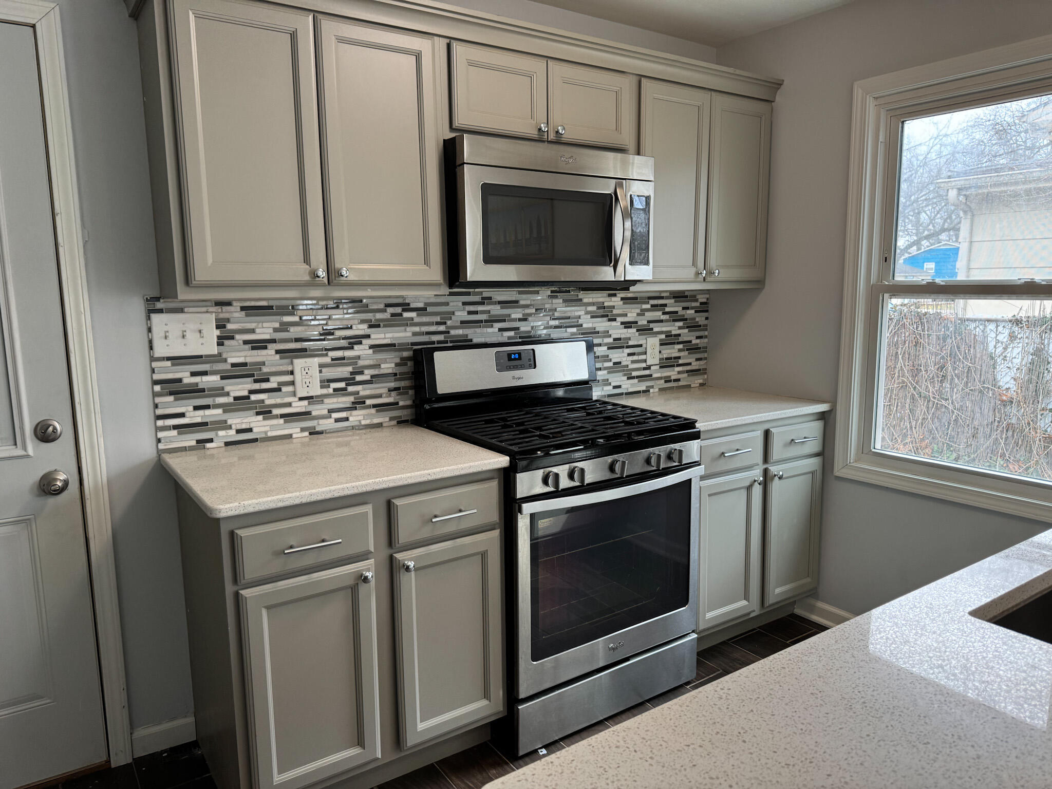 217 Loran Road Michigan City, IN 46360 - Photo 13 of 26 a kitchen with granite countertop white cabinets and stainless steel appliances