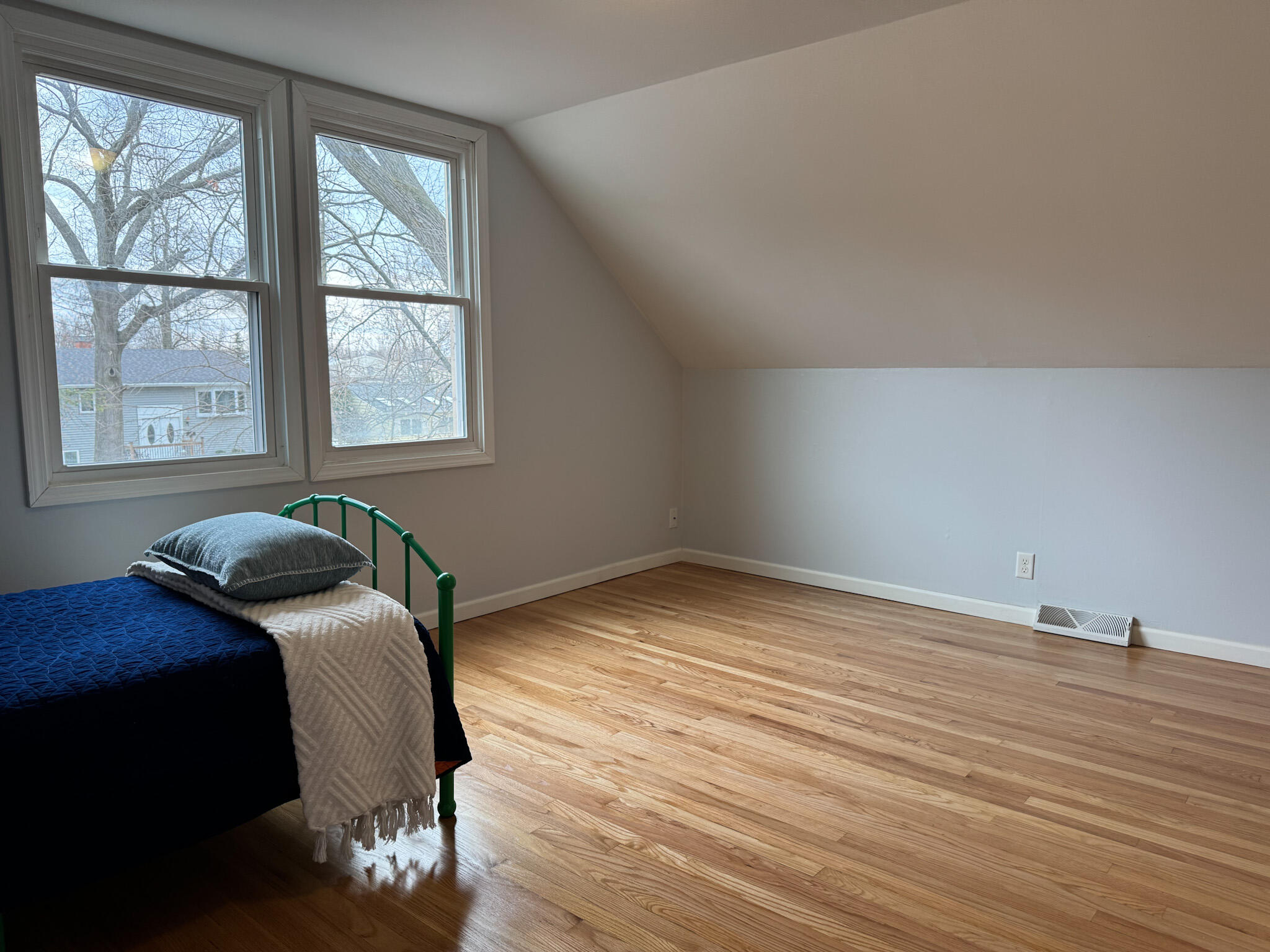 217 Loran Road Michigan City, IN 46360 - Photo 26 of 26 a bedroom with a bed and wooden floor