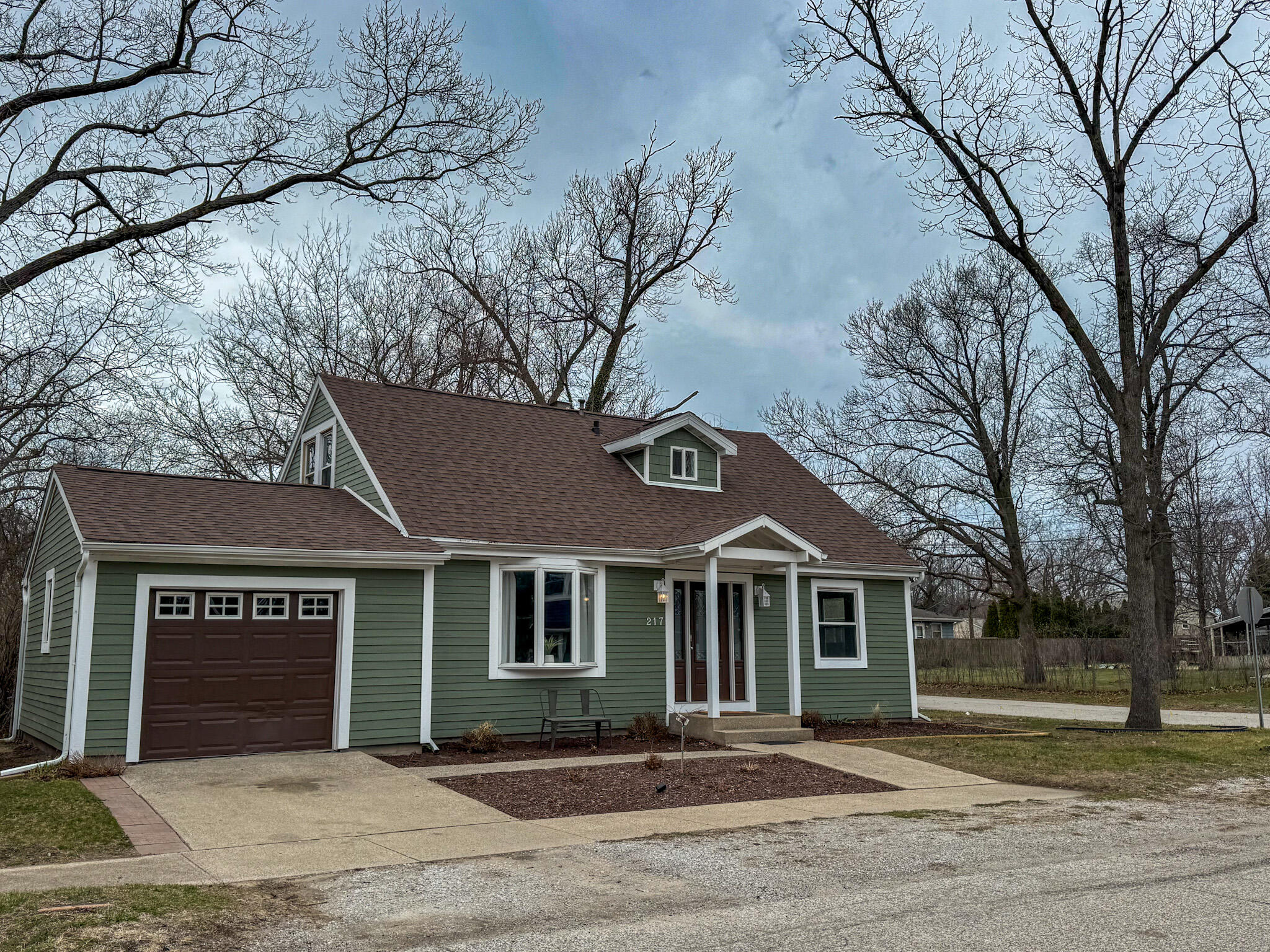 217 Loran Road Michigan City, IN 46360 - Photo 3 of 26 a front view of a house with a yard and garage