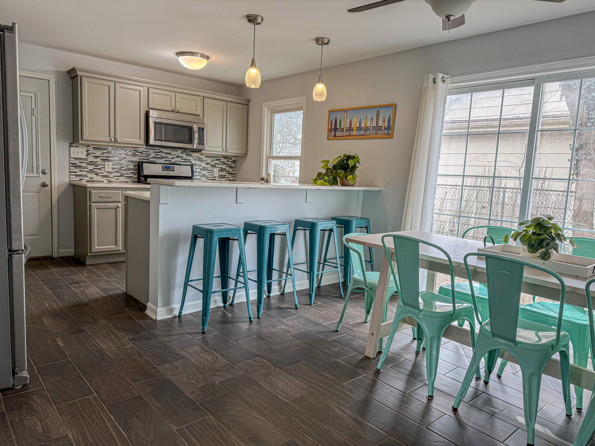 217 Loran Road Michigan City, IN 46360 - Photo 8 of 26 a open kitchen with granite countertop a table chairs microwave and cabinets
