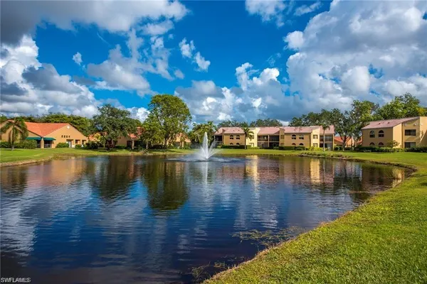 a view of a lake with houses in the background