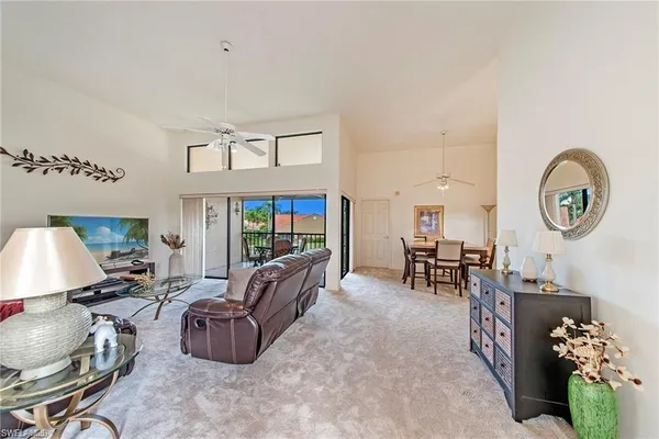 a living room with furniture a rug and a chandelier