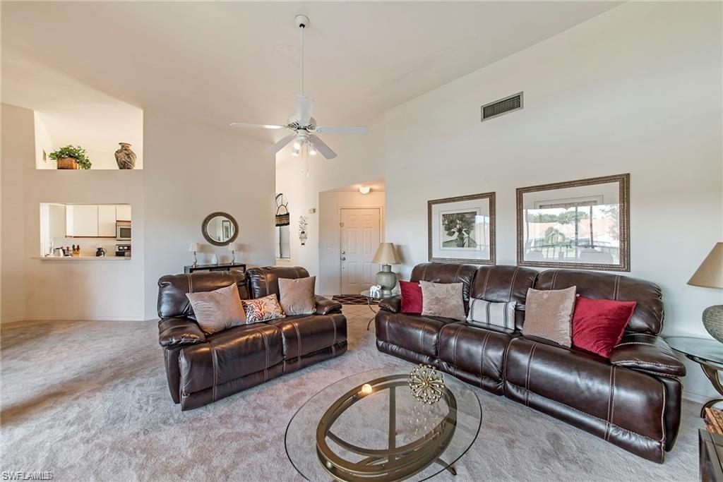 643 Beachwalk Circle, Unit D202 Naples, FL 34108 - Photo 13 of 22 a living room with furniture and a window