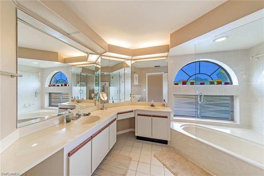 643 Beachwalk Circle, Unit D202 Naples, FL 34108 - Photo 14 of 22 a large kitchen with a sink a counter space and appliances