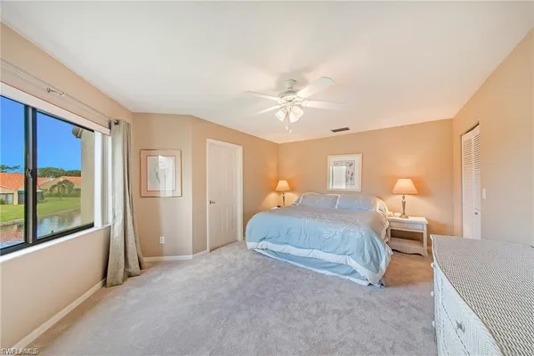 a bedroom with a large bed and a chandelier