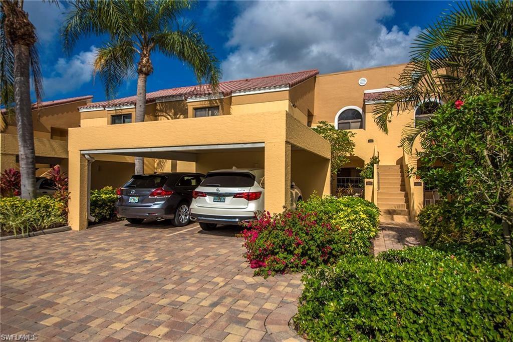 643 Beachwalk Circle, Unit D202 Naples, FL 34108 - Photo 5 of 22 a view of a cars parked in front of a building