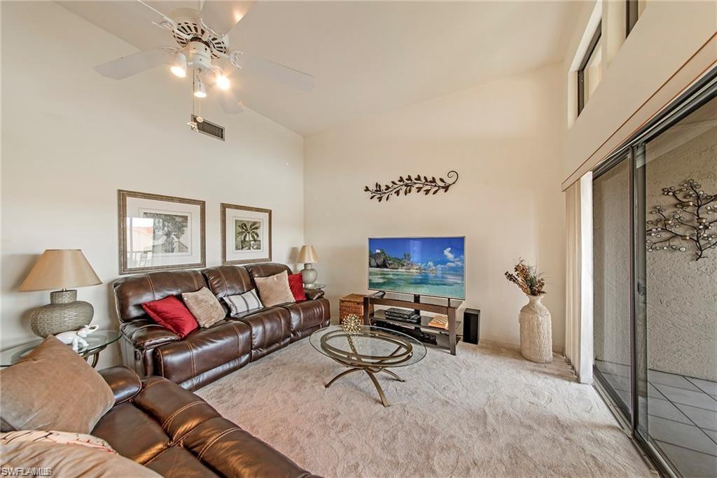 643 Beachwalk Circle, Unit D202 Naples, FL 34108 - Photo 9 of 22 a living room with furniture and a flat screen tv
