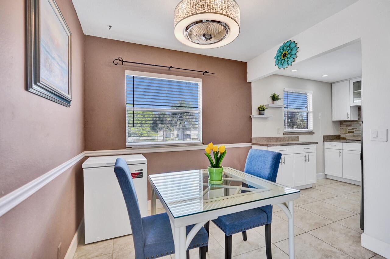 505 Monaco Way Delray Beach, FL 33446 - Photo 15 of 58 a view of a dining room with furniture window and wooden floor
