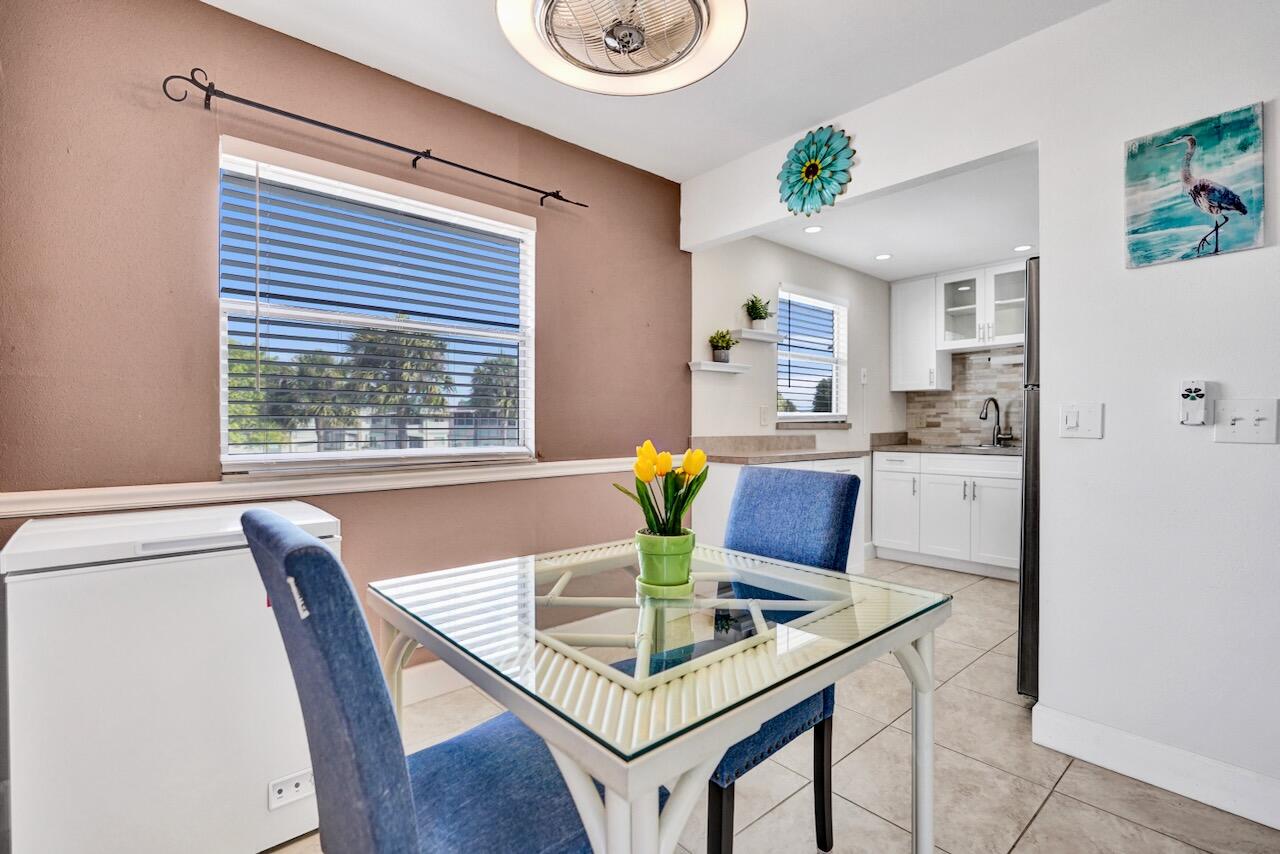 505 Monaco Way Delray Beach, FL 33446 - Photo 16 of 58 a dining room with furniture and a window