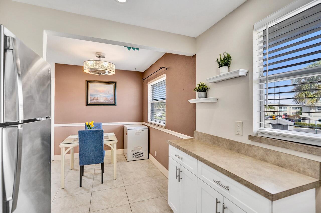 505 Monaco Way Delray Beach, FL 33446 - Photo 22 of 58 a kitchen with a table and chairs