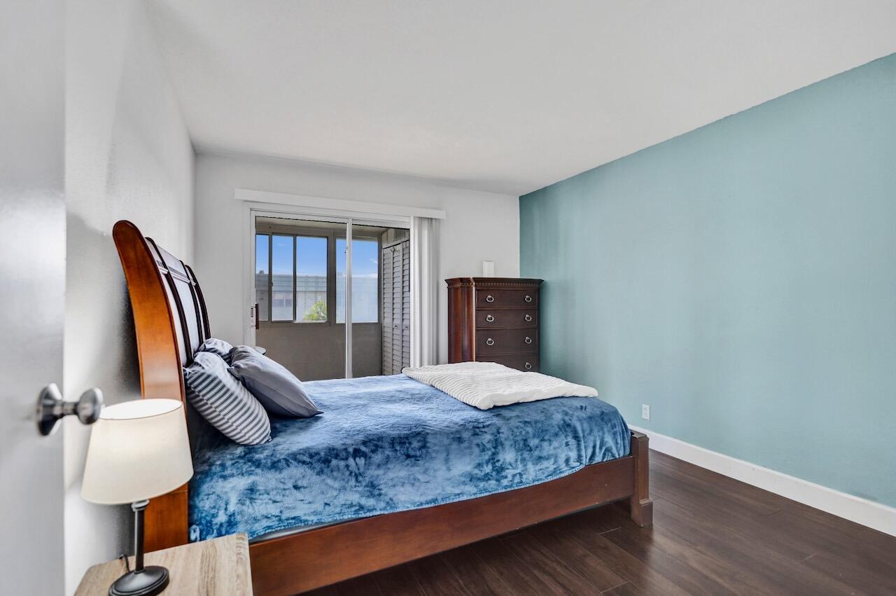 505 Monaco Way Delray Beach, FL 33446 - Photo 24 of 58 a bedroom with a large bed and wooden floor
