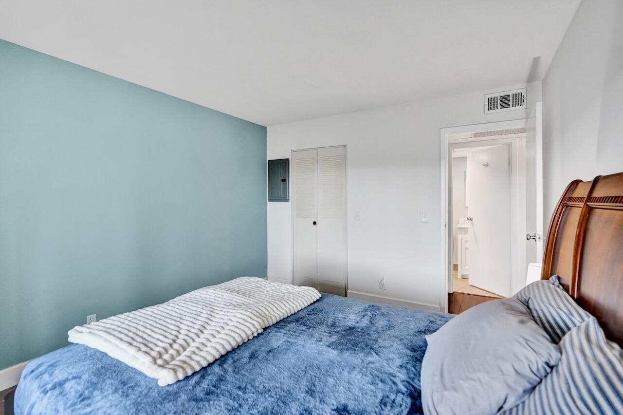 505 Monaco Way Delray Beach, FL 33446 - Photo 27 of 58 a bedroom with a bed and wooden floor