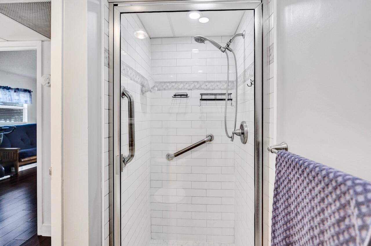 505 Monaco Way Delray Beach, FL 33446 - Photo 31 of 58 a bathroom with a glass shower door and a sink