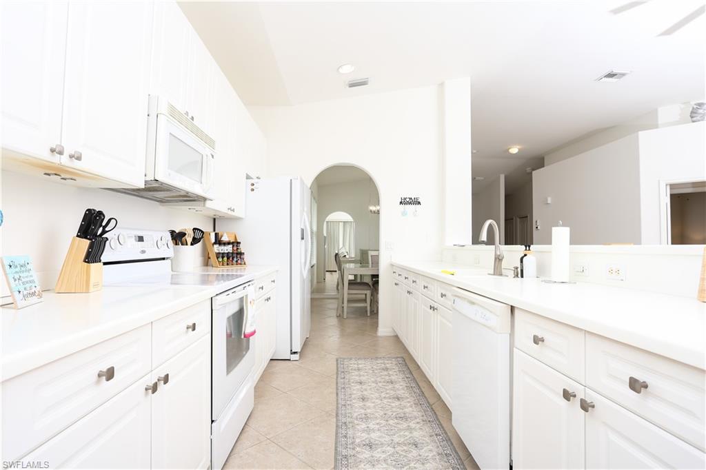 1937 Crestview Way, Unit 171 Naples, FL 34119 - Photo 11 of 39 a spacious bathroom with a double vanity sink and a mirror