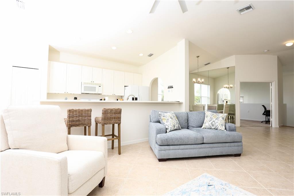 1937 Crestview Way, Unit 171 Naples, FL 34119 - Photo 15 of 39 a living room with furniture and a large window