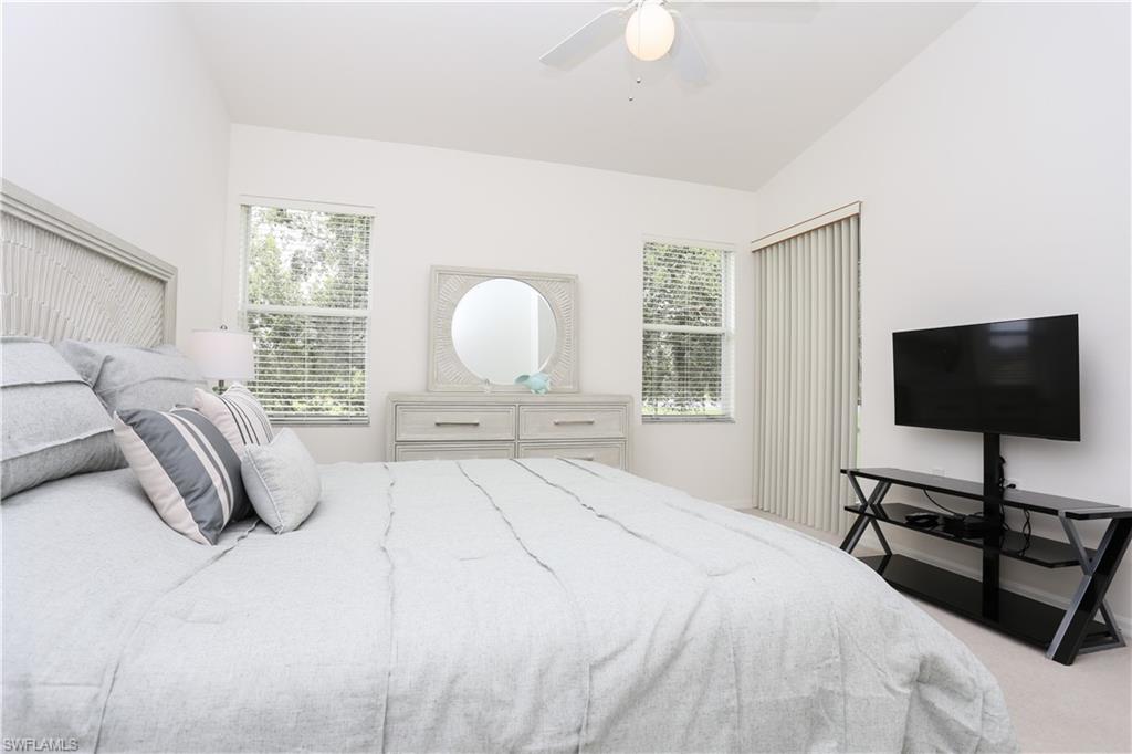 1937 Crestview Way, Unit 171 Naples, FL 34119 - Photo 16 of 39 a bedroom with a bed and a flat screen tv