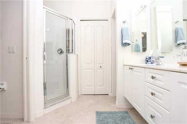 a bathroom with a shower sink and mirror