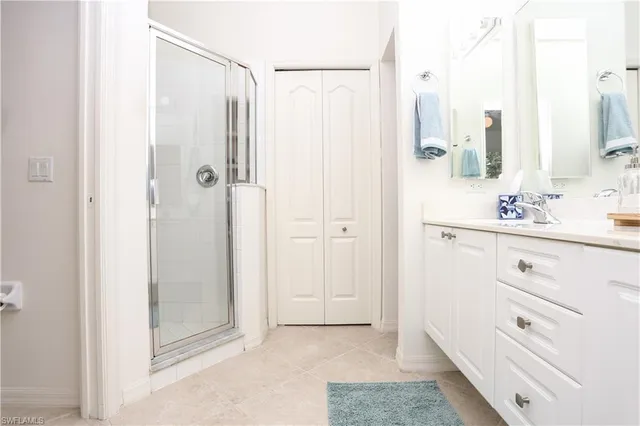 a bathroom with a shower sink and mirror