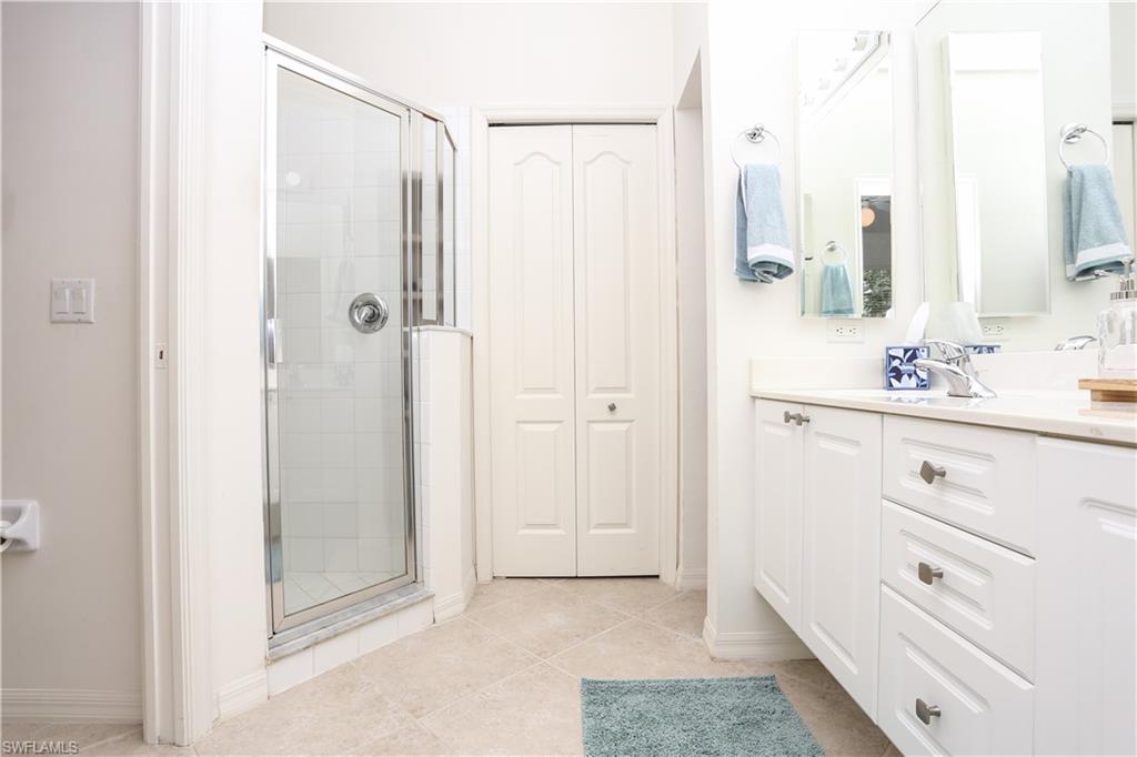 1937 Crestview Way, Unit 171 Naples, FL 34119 - Photo 19 of 39 a bathroom with a shower sink and mirror