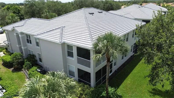 a aerial view of a house with a yard and potted plants