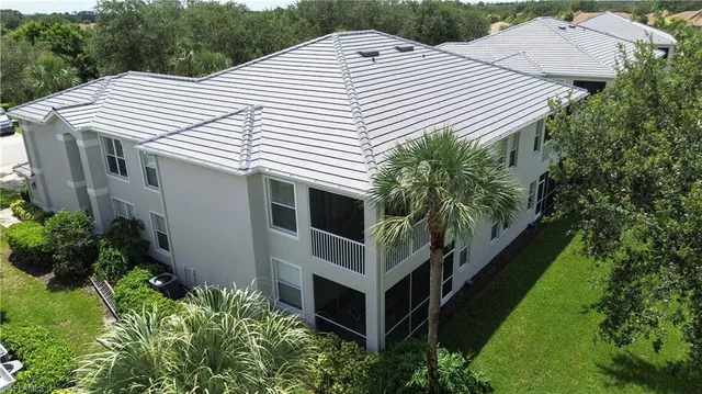 a aerial view of a house with a yard and potted plants