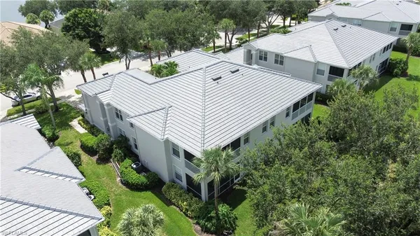 an aerial view of a house with a yard and potted plants