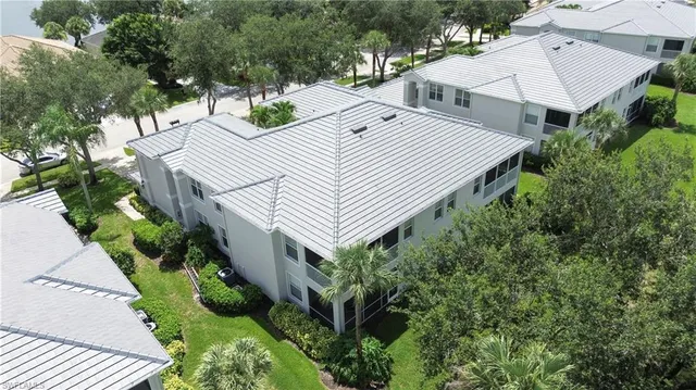 an aerial view of a house with a yard and potted plants