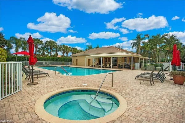 a view of a house with a swimming pool and sitting area