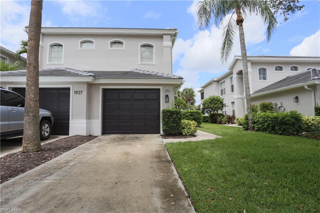 1937 Crestview Way, Unit 171 Naples, FL 34119 - Photo 4 of 39 a front view of a house with yard and garage