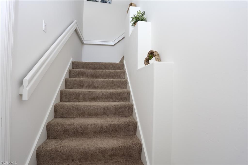 1937 Crestview Way, Unit 171 Naples, FL 34119 - Photo 6 of 39 a view of staircase with white walls