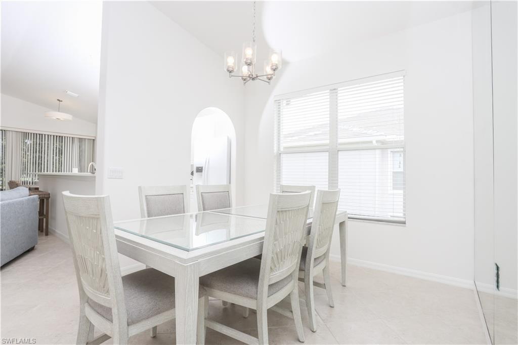1937 Crestview Way, Unit 171 Naples, FL 34119 - Photo 10 of 39 a dining room with furniture and window
