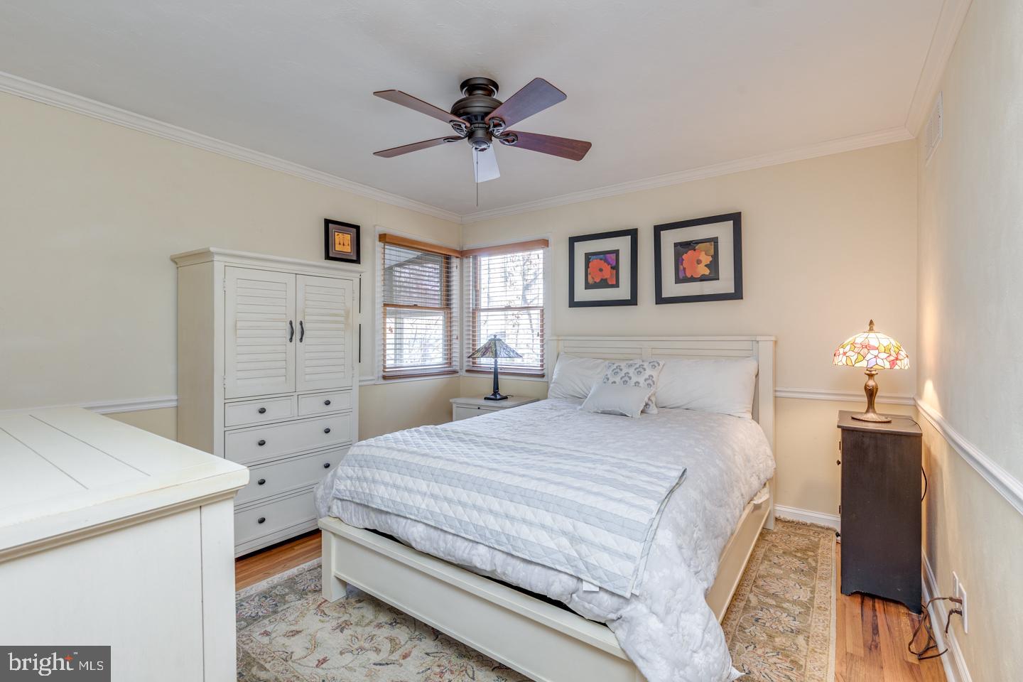 7 Forest Avenue Medford, NJ 08055 - Photo 19 of 43 a spacious bedroom with a bed and a chandelier
