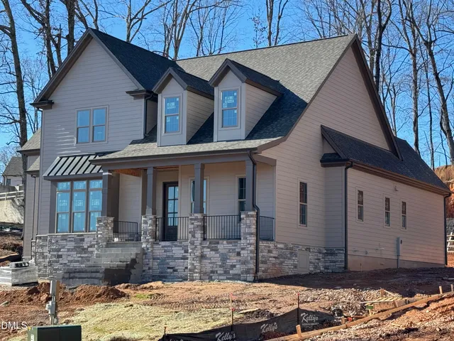 a front view of a house with two chairs
