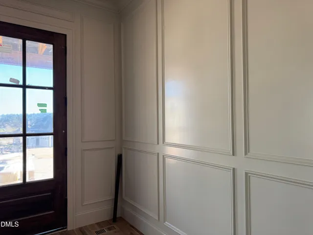 a view of wooden floor and windows in a room